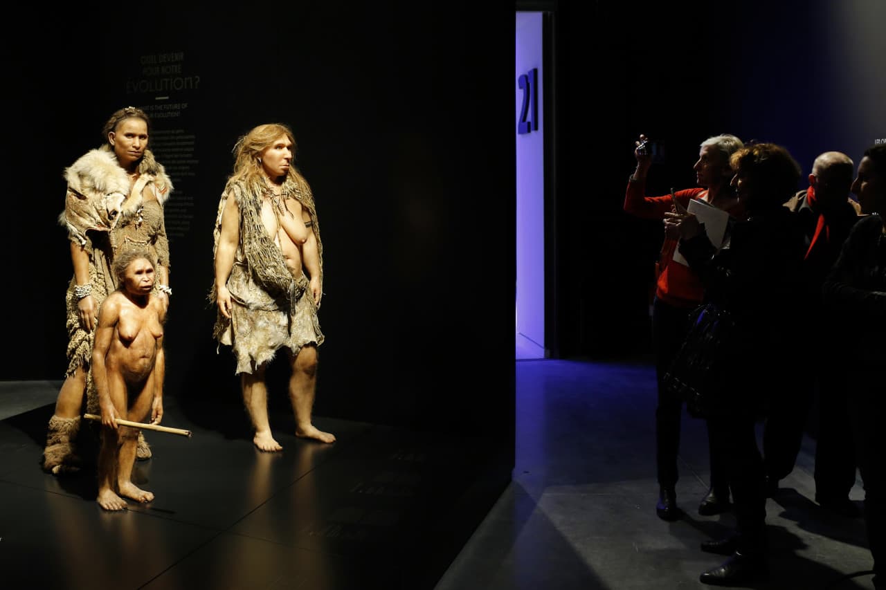 Visitors picture, from the left, models representing Flores, Homo Sapiens and Neanderthal women stand in the "Musee des Confluences", a new science and anthropology museum in Lyon, central France, Thursday, Dec. 18, 2014. (AP)