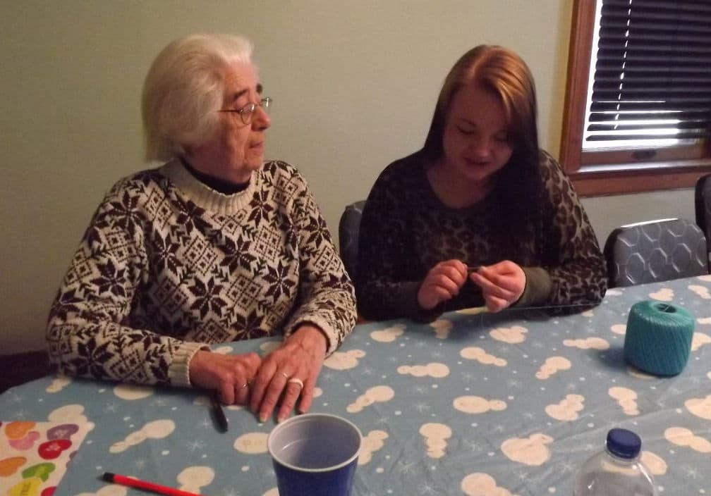 Sister Sue Kintzele crochets with a Dismas House Resident. (Courtesy Maria Kaczmarek)