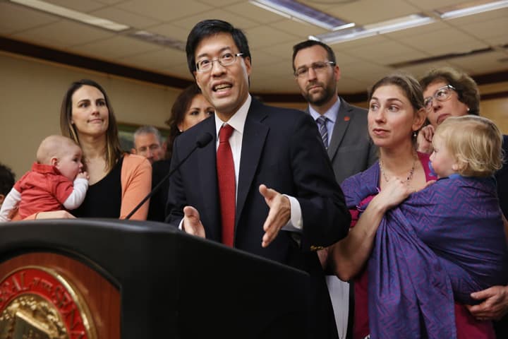 Sen. Richard Pan, D-Sacramento, center, accompanied by concerned mothers and their children, answers a question about his proposed legislation that would require parents to vaccinate all school children during a news conference in Sacramento, Calif., Wednesday Feb. 4, 2015. (AP)