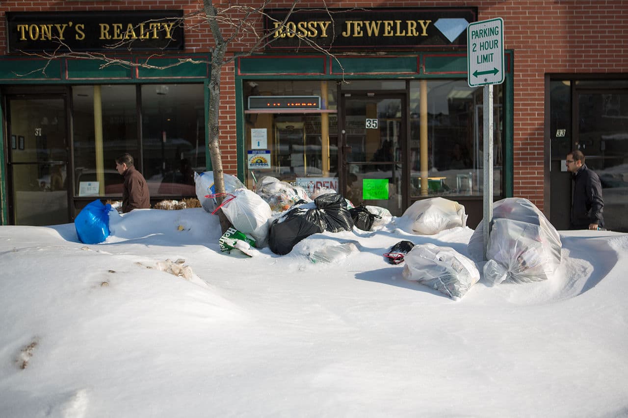 Trash bags were embedded in snow banks along Chelsea Street in East Boston last month. (Jesse Costa/WBUR)