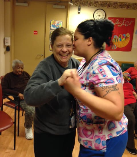 Brunhilda Ortiz dances with one of the staffers at Hebrew Home's night program. (Courtesy of the Hebrew Home at Riverdale)