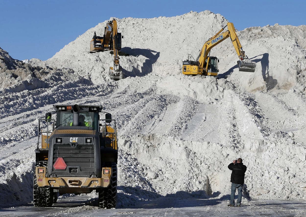 Heavy equipment worked on a mound of snow that had been cleared from city streets at a "snow farm" in Boston, Monday, Feb. 16. (Michael Dwyer/AP)