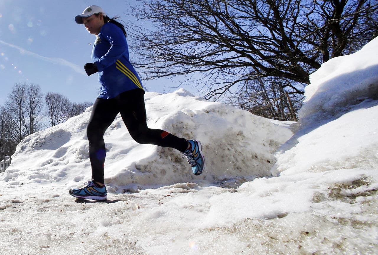 Runner Becca Pizzi, 34, trains along Heartbreak Hill in Newton. (Elise Amendola/AP)