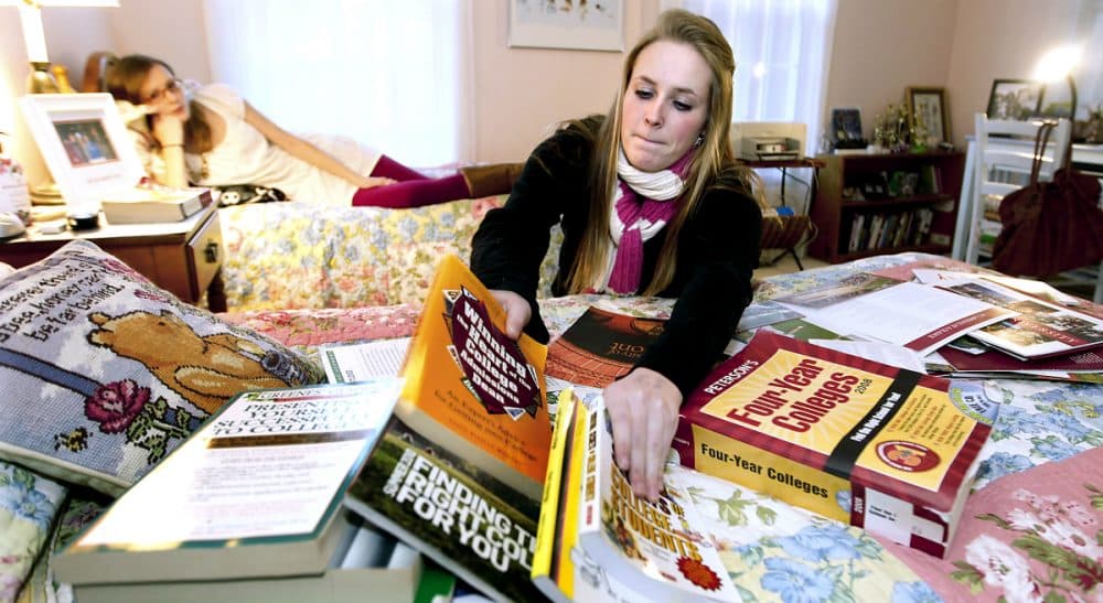 In this photo, Kim Pollock, 17, facing center, goes through college materials, as her sister Lindsay, 15, back left, watches, in her bedroom in Bedford, N.H., Thursday, Nov. 11, 2010. (Cheryl Senter/AP)