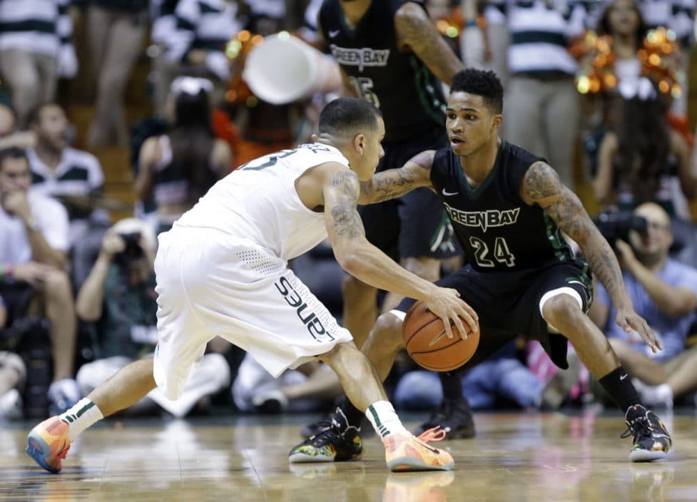 Green Bay's Keifer Sykes (right) is an NBA prospect -- and a father. (Lynne Sladky/AP)