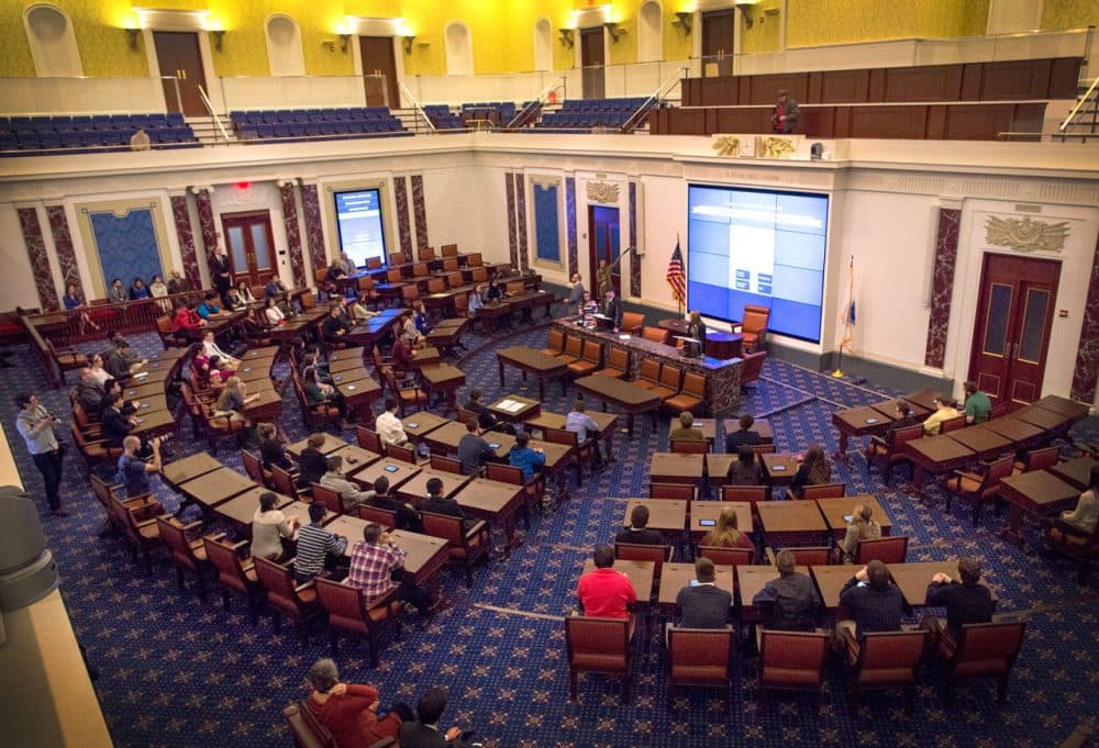 At the center of the Edward M. Kennedy Institute for the U.S. Senate is replica of the real U.S. Senate chamber — a majestic room with gilded wallpaper and wooden desks modeled off the original congressional furniture. (Robin Lubbock/WBUR)