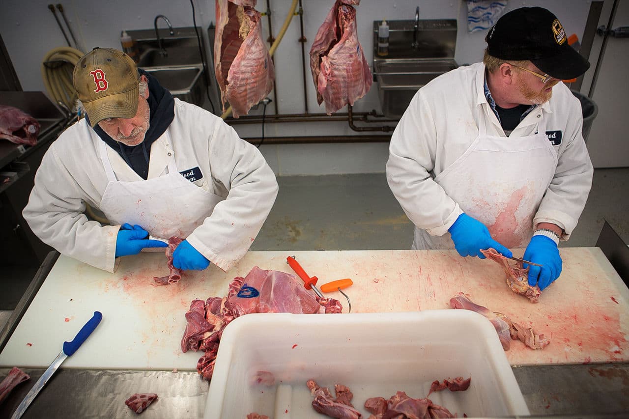 Brian Basili and Don Labrie process cuts of veal. Blood Farm is a small operation, with just 15 employees. (Jesse Costa/WBUR)