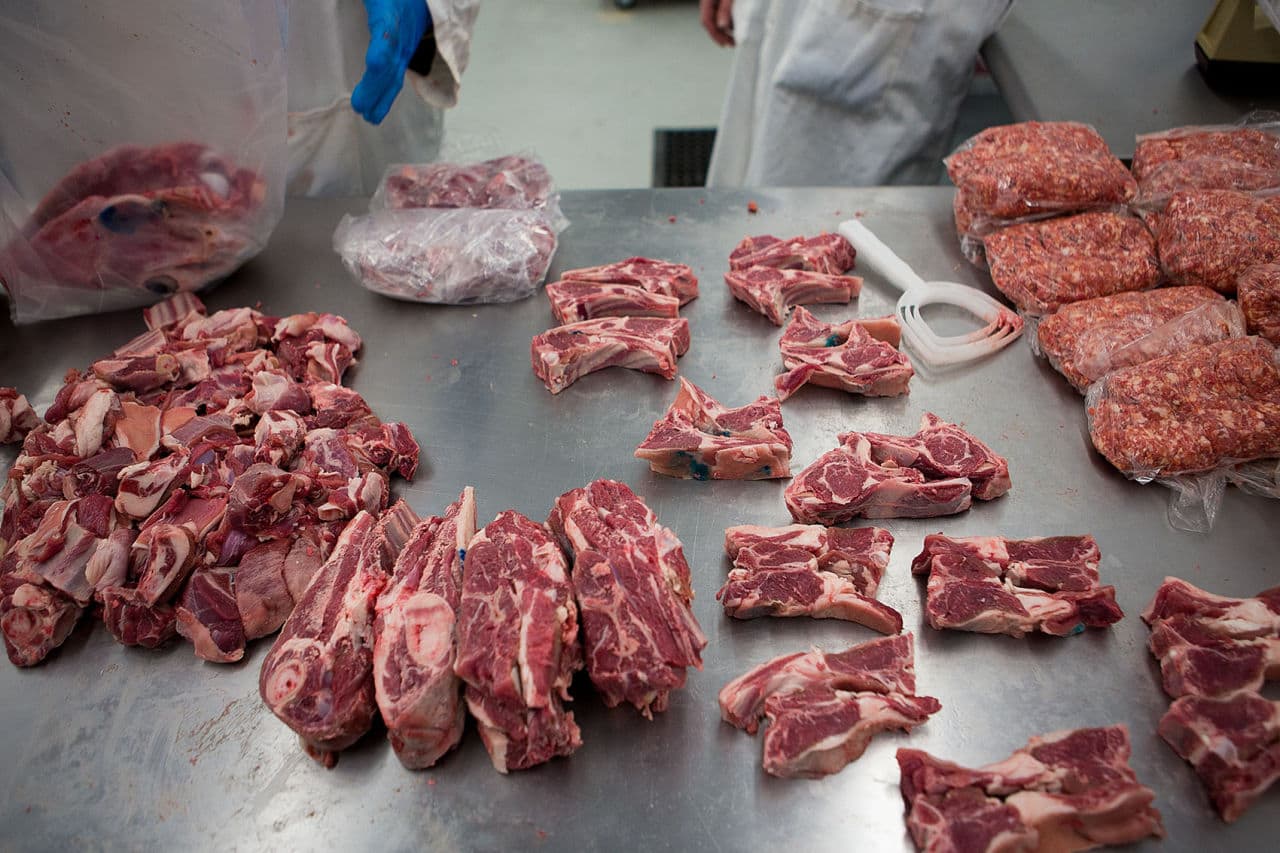 A table full of veal inside Blood Farm's processing facility. Jay Healy, who works for the government agency that regulates slaughter and meat processing, says demand for locally-raised meat in New England has grown five-fold over the last decade, and he calls Blood Farm a critical link in the food chain. (Jesse Costa/WBUR)