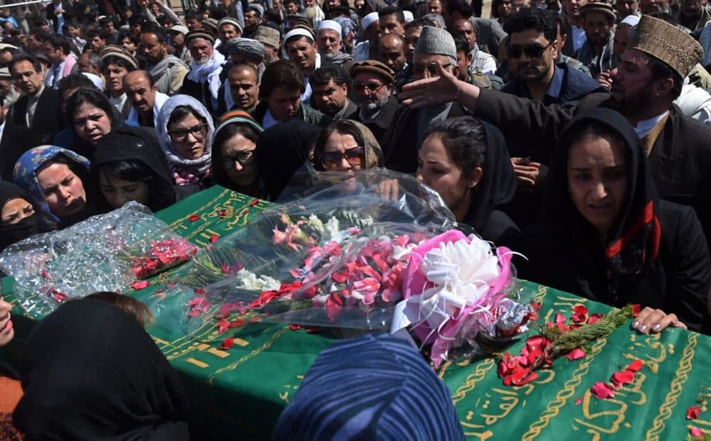Hundreds of people  attended the burial of an Afghan woman on Sunday. She was beaten to death and set on fire by a mob for allegedly burning a copy of the Qur'an.  (Wakil Kohsar/AFP/Getty Images)