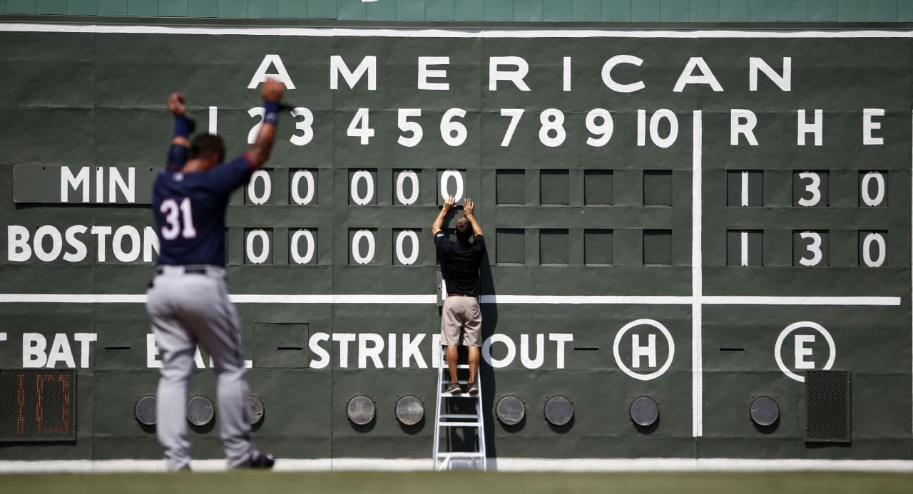 This scoreboard likely looks familiar to Boston Red Sox fans. Down at the team's spring training facility, Sox intern Tim Batesole changes the scoreboard during a game on March 18 in Fort Myers, Fla. (Brynn Anderson/AP)
