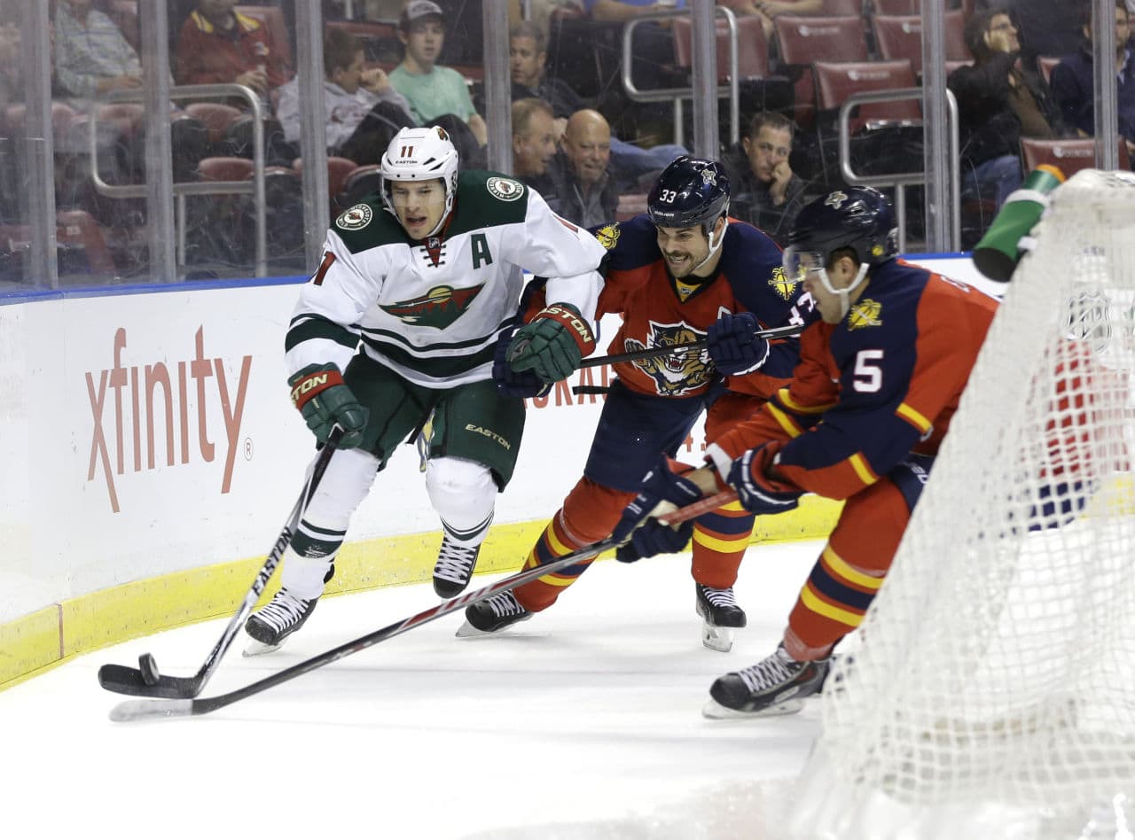Willie Mitchell (center) is a 37-year-old NHL veteran. He invited 19-year-old teammate Aaron Ekblad (right) to live with him and his wife, Megan, after the fellow defenseman made the roster. (AP Photo/Lynne Sladky)