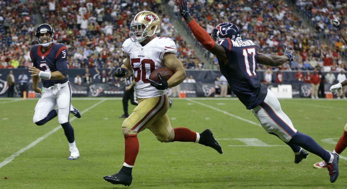 NFL rookie Chris Borland quits after one season, and an actor declines an offer to be the voice of the sport. Pictured: Borland, playing for the San Francisco 49ers, runs an interception back for a touchdown past Houston Texans' Uzoma Nwachukwu during the third quarter of an NFL football preseason game Thursday, Aug. 28, 2014, in Houston. (Patric Schneider/AP)