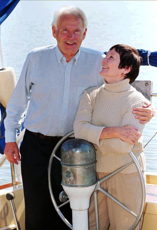 Sloan Wilson gives his wife, Betty, a hug in the cockpit of their sailboat "Pretty Betty" in Colonial Beach, Va., in 1995. Forty years ago Wilson wrote "The Man in the Gray Flannel Suit."(AP/Steve Helber)