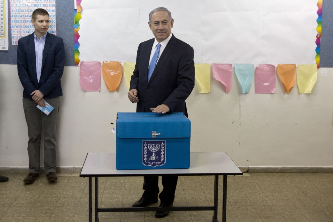 Israeli Prime Minister Benjamin Netanyahu casts his vote during Israel's parliamentary elections in Jerusalem, Tuesday, Mar. 17, 2015. His Likud party would go on to win the most seats in a divided Israeli legislature, virtually guaranteeing the controversial leader a fourth term in office. (AP)