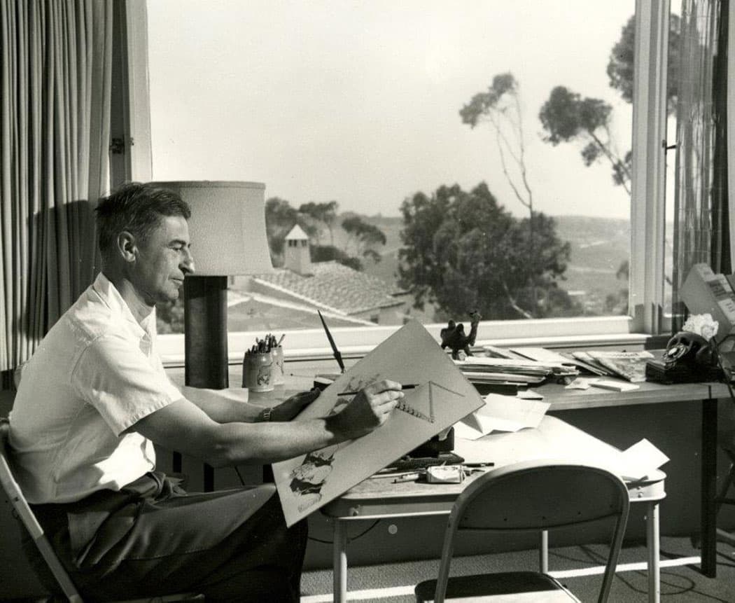 Theodor Geisel at his drawing table. (Wood Museum of Springfield History)