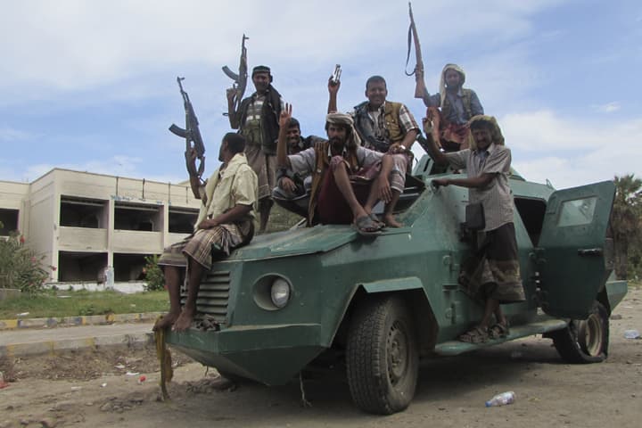 In this photo taken on Friday, March 20, 2015, militiamen loyal to President Abed Rabbo Mansour Hadi ride on an army vehicle on a street in Aden, Yemen. (AP)