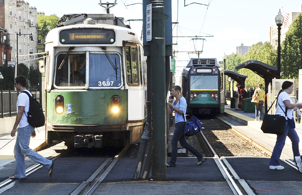 People walk by the Green Line along Commonwealth Avenue in Boston, in this 2008 file photo. (Lisa Poole/AP)
