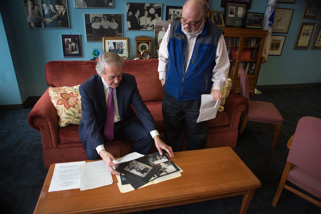 U.S. Sen Ed. Markey shows WBUR's Bob Oakes his files and photos pertaining to Richard Fitzgibbon Jr. Markey's efforts helped amend the war's start date and get the elder Fitzgibbon on the Vietnam wall. (Jesse Costa/WBUR)