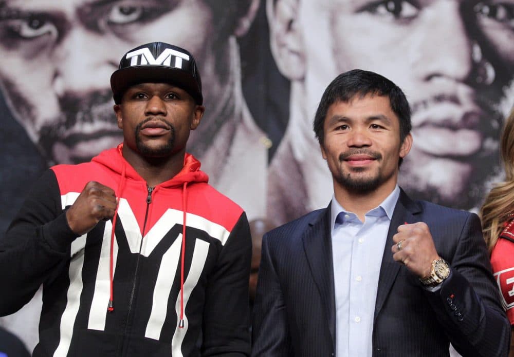 WBC/WBA welterweight champion Floyd Mayweather Jr. (left) and WBO welterweight champion Manny Pacquiao pose during a news conference at the KA Theatre at MGM Grand Hotel & Casino on April 29, 2015 in Las Vegas, Nevada. The two will face each other in a unification bout on May 2, 2015 in Las Vegas. (John Gurzinski/AFP/Getty Images)