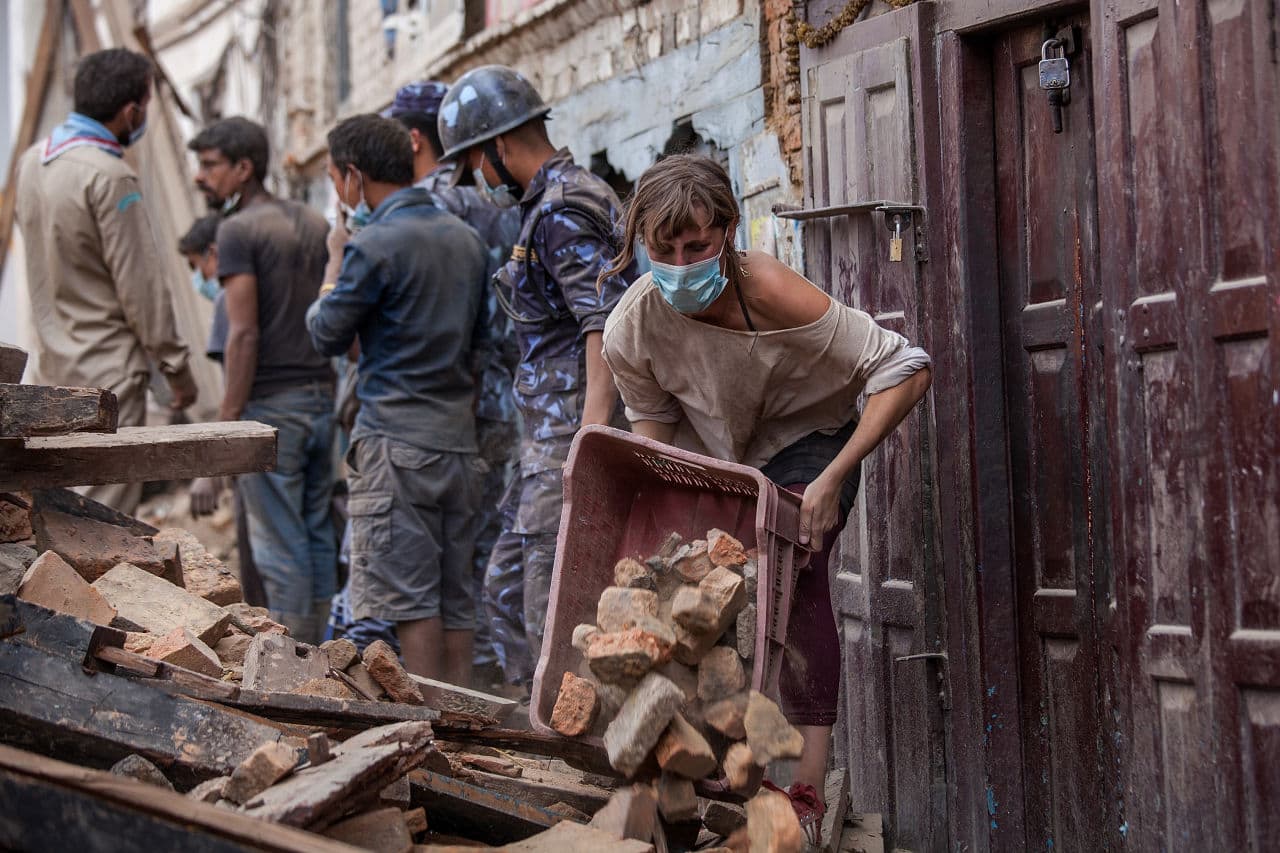 A foreign volunteer clears debris of a collapsed temple at Basantapur Durbar Square on April 27, 2015 in Kathmandu, Nepal. (Omar Havana/Getty Images)