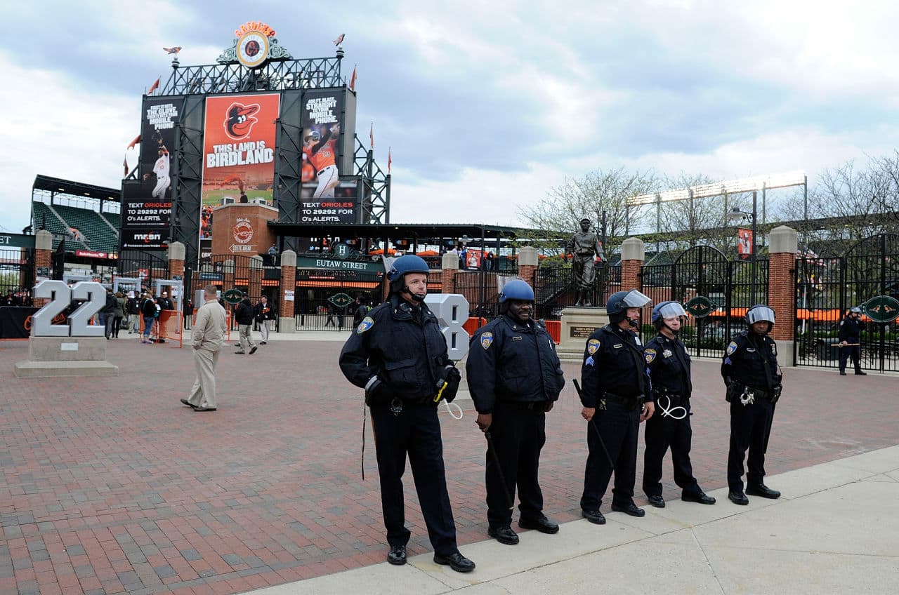 Police stand watch outside Oriole Park at Camden Yards before the game was postponed between the Baltimore Orioles and the Chicago White Sox on April 27, 2015 in Baltimore, Maryland. The move comes amid violent clashes between police and youths, according to news reports, the aftermath of the death of Freddie Gray on April 19 after suffering a fatal spinal injury while in police custody. (Photo by Greg Fiume/Getty Images)