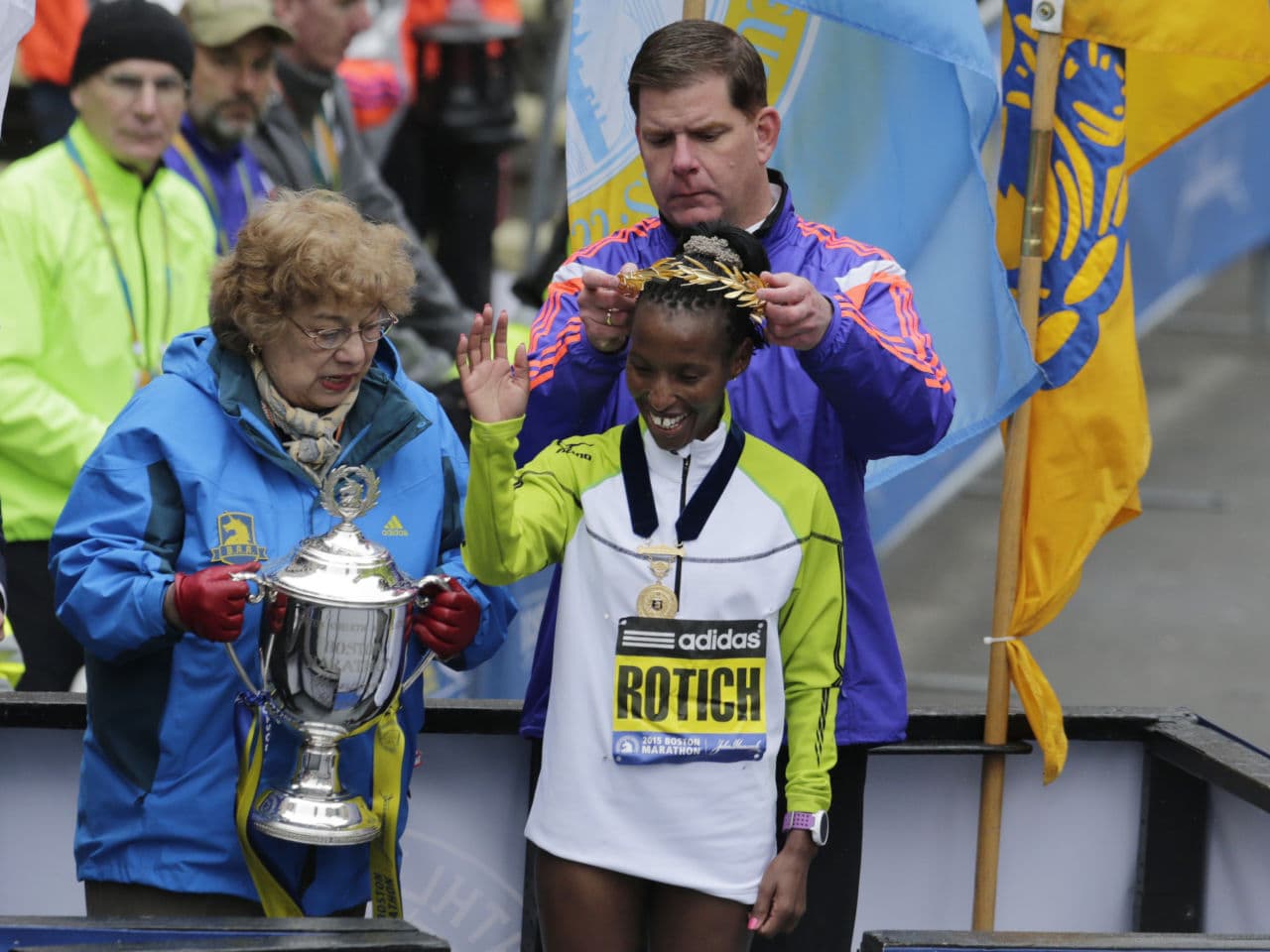 Boston Mayor Marty Walsh crowns Caroline Rotich, of Kenya, after she won the women's division of the Boston Marathon. (Elise Amendola/AP)