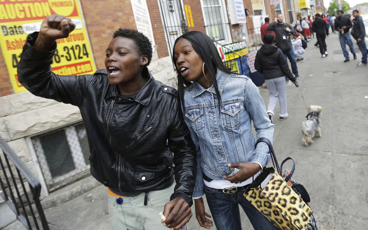 Charvae Day, right, and Renay Battle react to Mosby's announcement of criminal charges against six officers suspended in connection with Gray's death. (David Goldman/AP)