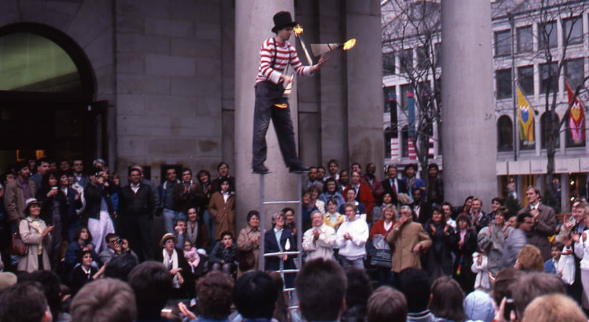 The managers of Faneuil Hall Marketplace are demanding that artists there pay between $500 and $2,500 for the privilege of earning tips and vending small wares. In this 1988 archive photo, a juggler performs at Faneuil Hall Marketplace. (Peter H. Dreyer/City of Boston Archives)