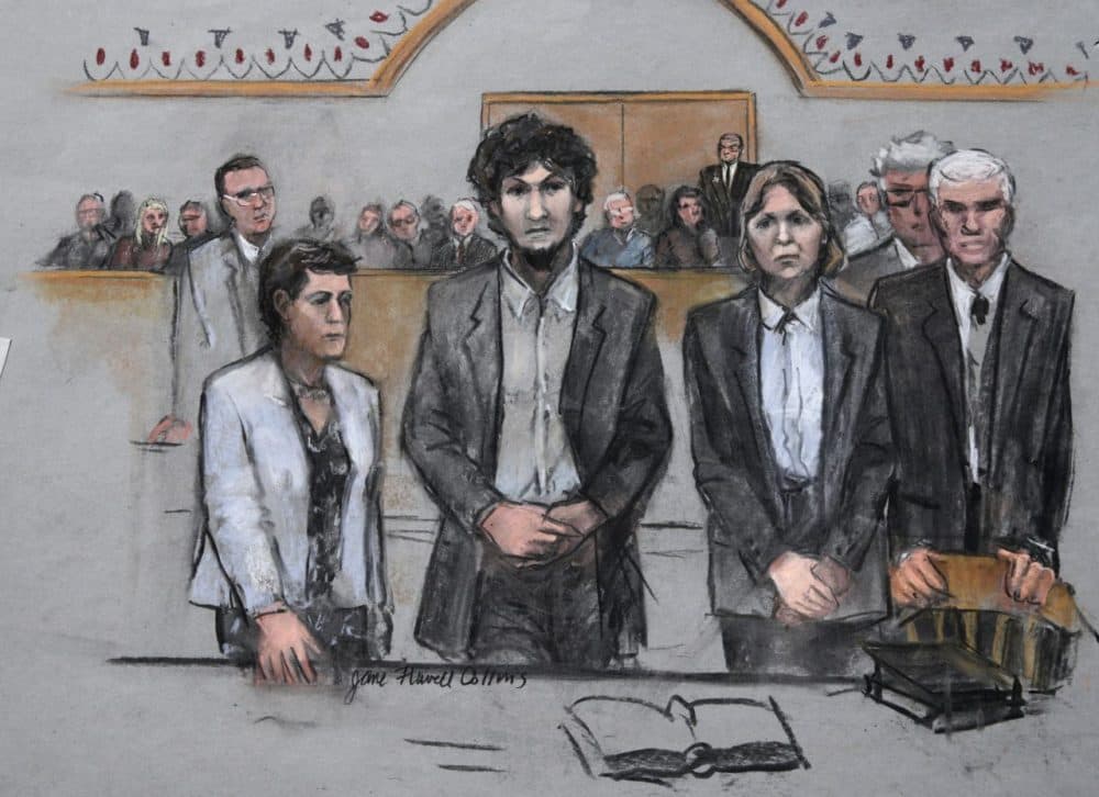 In this courtroom sketch, Dzhokhar Tsarnaev stands with his defense attorneys as a death sentence is read in his case. (Jane Flavell Collins/AP)