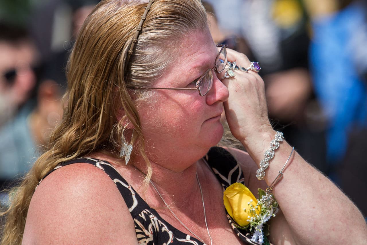 Sharon Maguire wipes away tears during Governor Baker’s remarks. (Jesse Costa/WBUR)