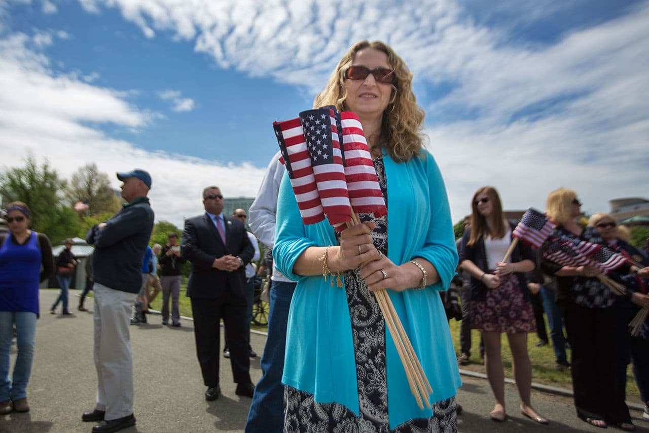 Erica Zeiger, director of the Massachusetts Legacy Fund, awaits her turn to plant flags. (Jesse Costa/WBUR)