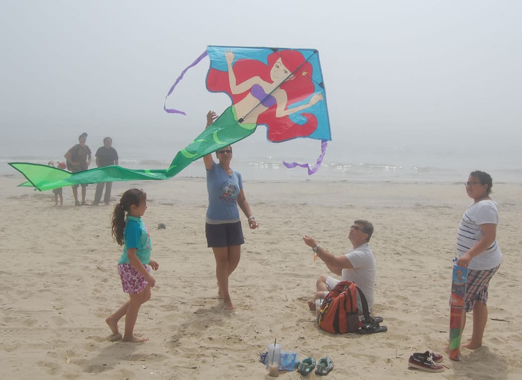 Launching a mermaid kite at the Revere Beach Kite Festival. (Greg Cook)