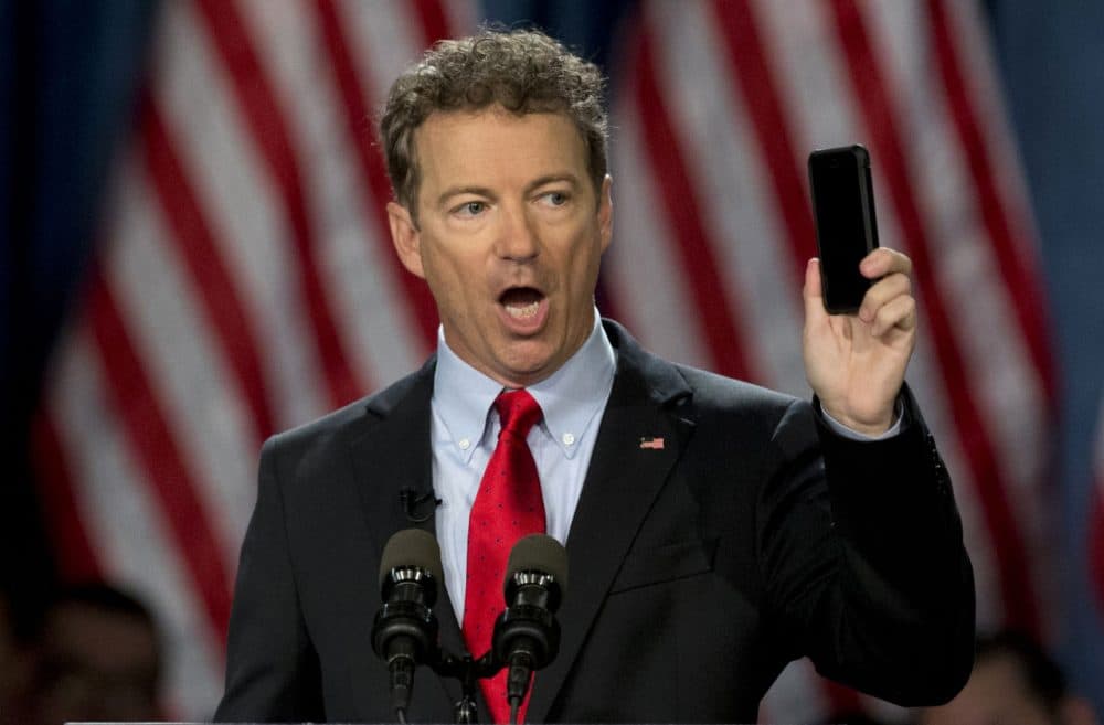 Sen. Rand Paul holds up his cell phone as he speaks before announcing the start of his presidential campaign, in Louisville, Ky. (Carolyn Kaster/AP)
