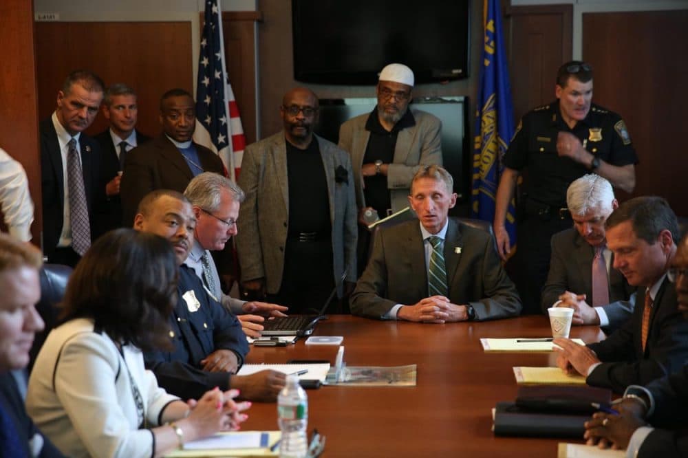 Boston community and religious leaders and police officials at police headquarters prepare to see video Wednesday of a fatal police shooting on Tuesday, in the city's Roslindale neighborhood. (David Ryan/The Boston Globe/AP)