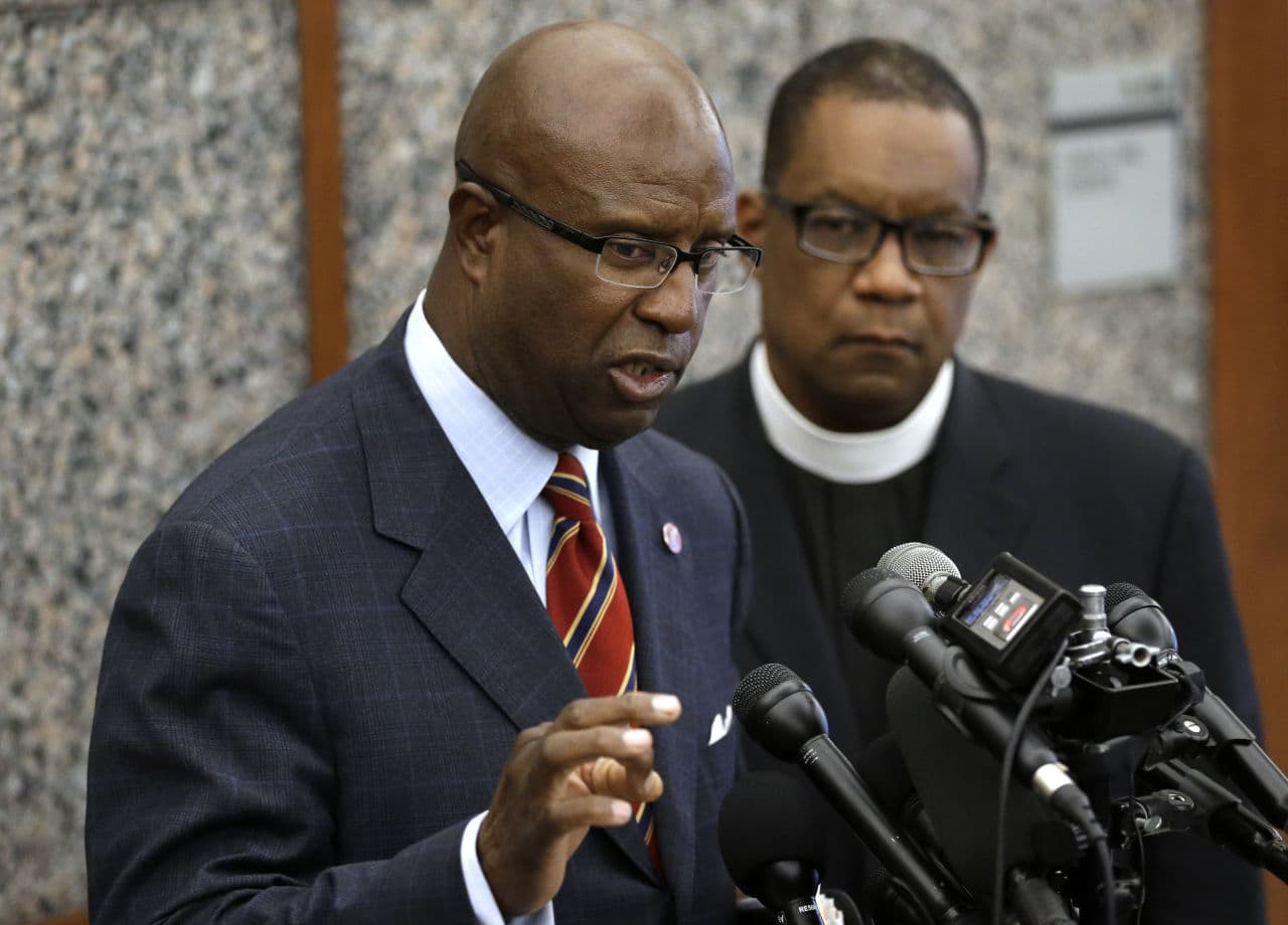 Darnell Williams, head of the Urban League of Eastern Massachusetts, left, speaks with reporters during a news conference Wednesday as Rev. Mark Scott, of the Azusa Christian Community church, looks on. (Steven Senne/AP)