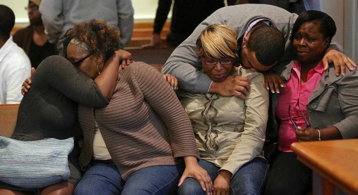 The family and supporters of Dushawn Taylor-Gennis, including his mother Genneane Gennis, seated second from right, react at the end of the session in Dorchester Municipal Court in Boston, Monday, June 15, 2015. Taylor-Gennis and Raeshawn Moody have been charged with gunning down Jonathan Dos Santos out riding his bike and have been held without bail. (Pat Greenhouse/AP)