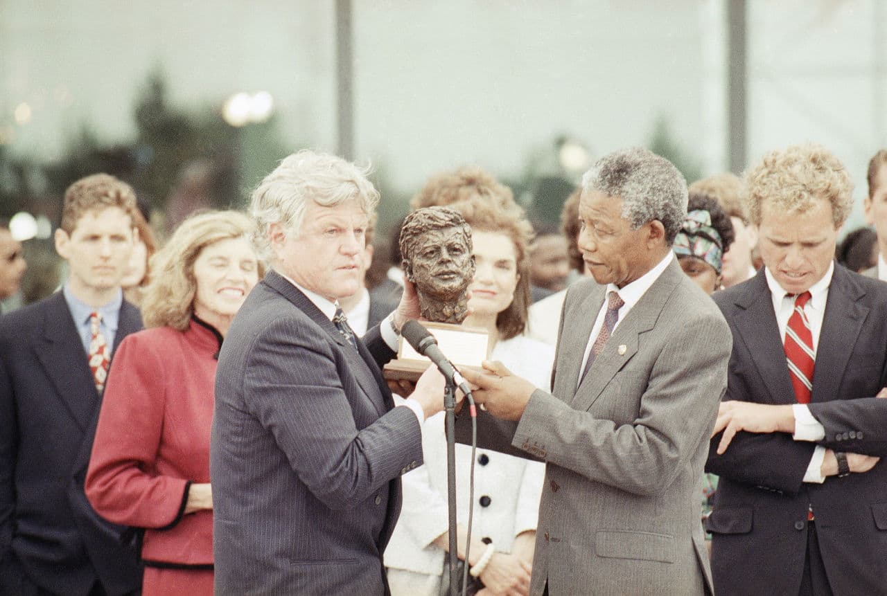 Nelson Mandela receives a bust of the late president John F. Kennedy from the president's brother Sen. Edward Kennedy, left, during a ceremony at the John F. Kennedy library in Boston Saturday, June 23, 1990. (Charles Krupa/AP)