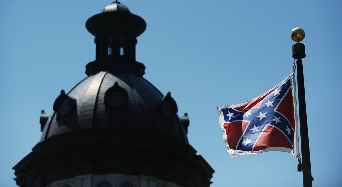In this Friday, June 19, 2015 file photo, the Confederate flag flies near the South Carolina Statehouse, in Columbia. For years, lawmakers refused to consider removing the Confederate flag from Statehouse grounds, but opinions changed within days of the massacre of nine people at Emanuel African Methodist Episcopal church in Charleston. (Rainier Ehrhardt/AP)