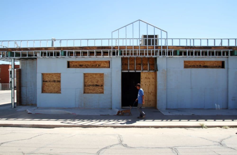A man walks past the former site of a clinic that offered abortions in El Paso, Texas, on Oct. 3, 2014. Abortion services for many Texas women require a round trip of more than 200 miles or a border-crossing into Mexico or New Mexico after federal appellate judges allowed full implementation of a law that has closed more than 80% of Texas' abortion clinics. (Juan Carlos Llorca/AP)
