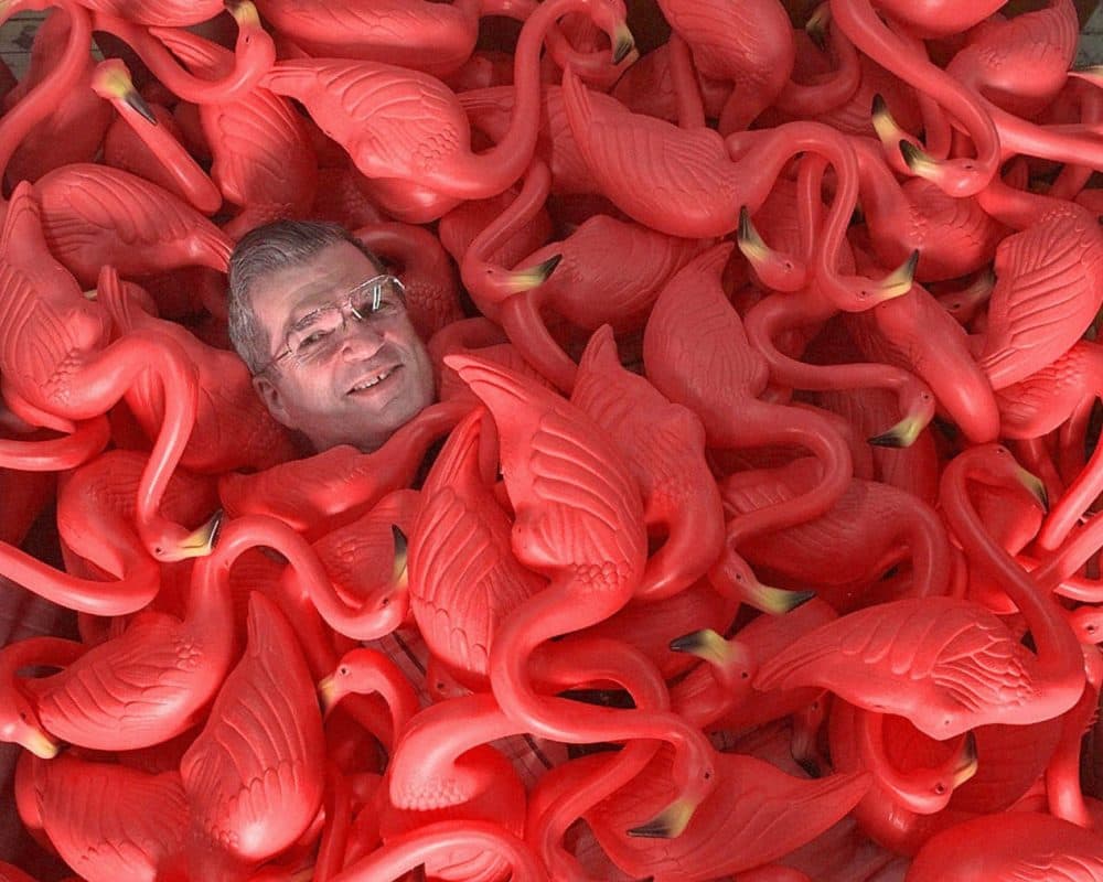 In this Thursday, June 25, 1998 photo, Don Featherstone, creator of the original plastic pink flamingo, sits surrounded by many of the plastic creatures at Union Products, Inc. in Leominster, Mass. (Amy Sancetta/AP)