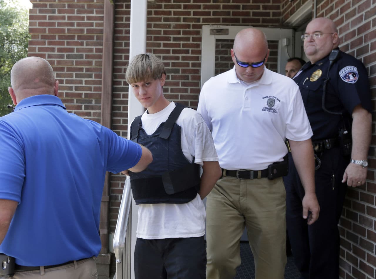 Dylann Storm Roof, center, who is alleged to have shot and killed nine people in a historic church in Charleston, South Carolina, was captured in North Carolina without resistance Thursday after an all-night manhunt. (Chuck Burton/AP)