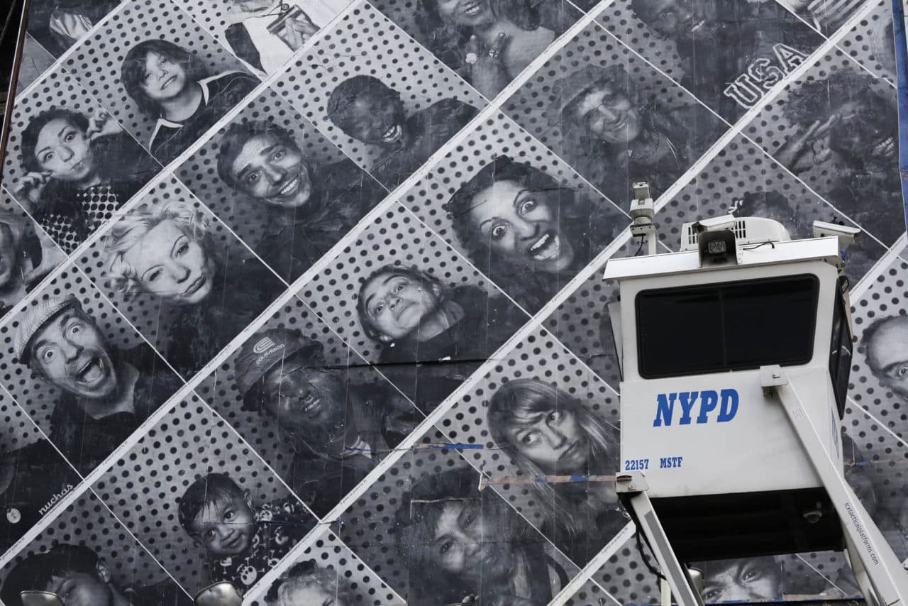 In this file photo, a New York Police Department SkyWatch observation tower is stationed in midtown Manhattan, Wednesday, July 31, 2013 in New York. Behind it is a billboard filled with people's photographs. (AP)