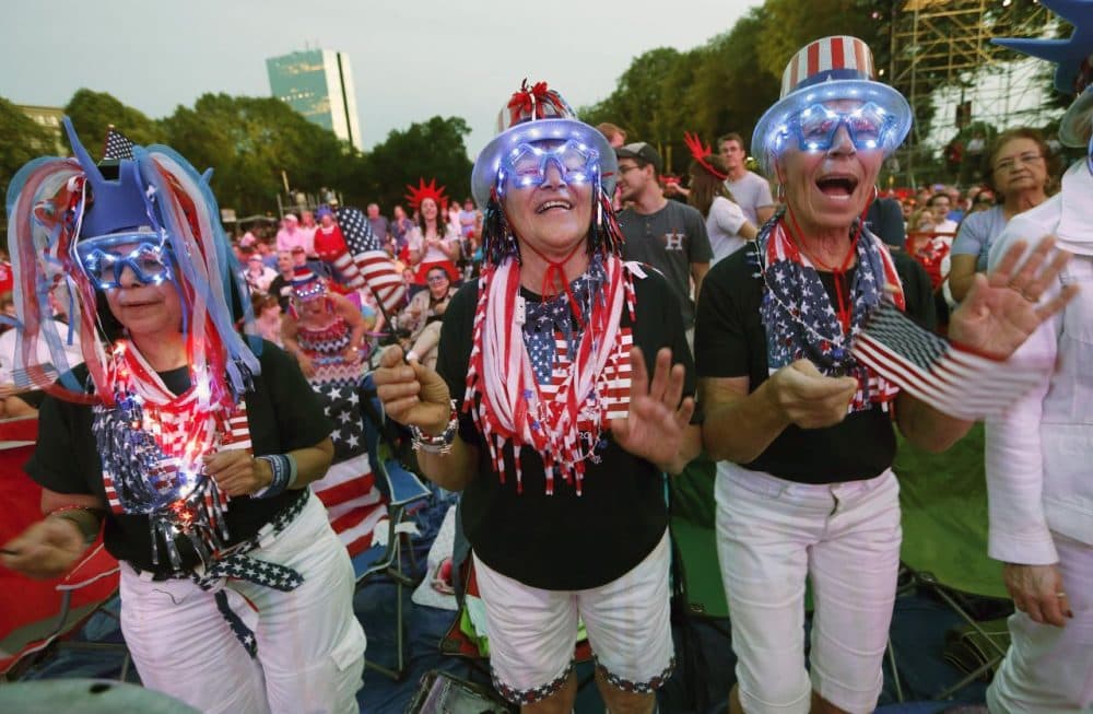 Spectators, from left, Mary Ann Rollings, Gloria Kelley and Linda Stacey applaud during rehearsal for the annual Boston Pops orchestra Fourth of July concert at the Hatch Shell in Boston, Friday, July 3, 2015. (Michael Dwyer/AP)