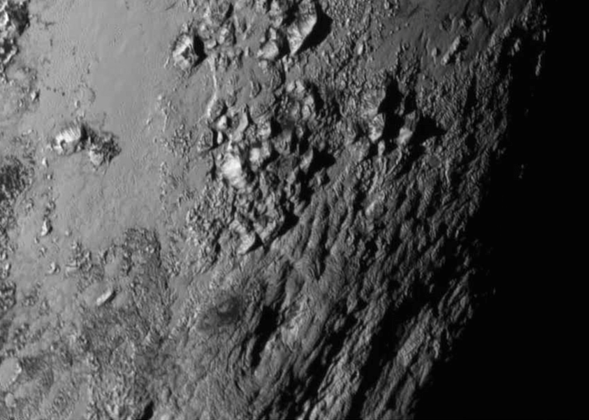 New close-up images of a region near Pluto’s equator reveal a giant surprise -- a range of youthful mountains rising as high as 11,000 feet (3,500 meters) above the surface of the icy body. (Credits: NASA/JHU APL/SwRI)
