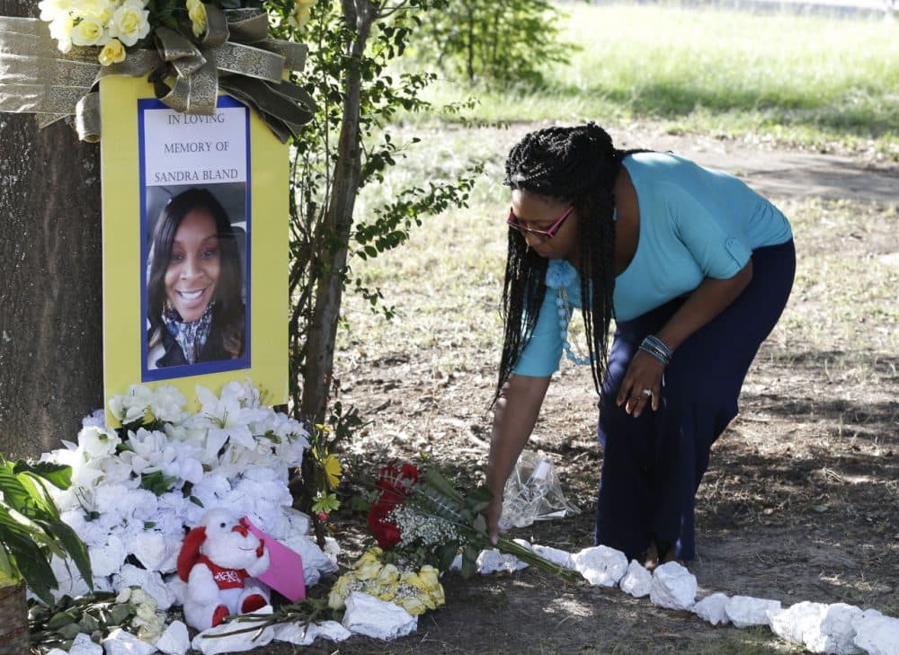 Jeanette Williams places a bouquet of roses at a memorial for Sandra Bland. (Pat Sullivan/AP)