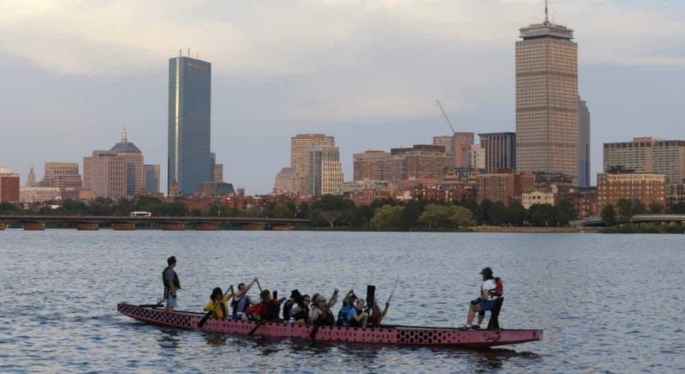 E.M. Swift: The hub's Olympic bid was so delusional, it was misleading. In this photo, a boat glides along the Cambridge, Mass., side of the Charles River, Monday, July 27, 2105, in front of the Boston skyline, behind. The U.S. Olympic Committee officially severed ties with Boston on Monday, saying it was exploring other options amid lackluster public support and concerns from elected leaders and organized opposition about the impact to taxpayers. (Steven Senne/AP)