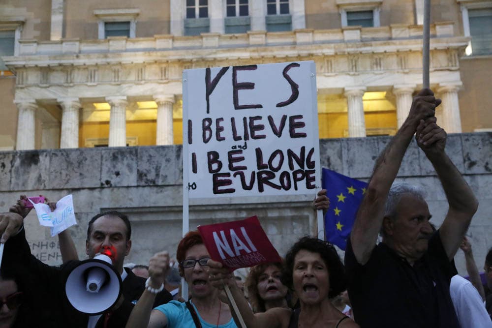 Demonstrators shout slogans during a rally organized by supporters of the YES vote for the upcoming referendum in front of the Greek Parliament in Athens, Tuesday, June 30, 2015 Greece's European creditors were assessing a last-minute proposal Athens made for a new two-year rescue deal, submitted just hours before the country's international bailout program expires and it loses access to billions of euros in funds. (AP)