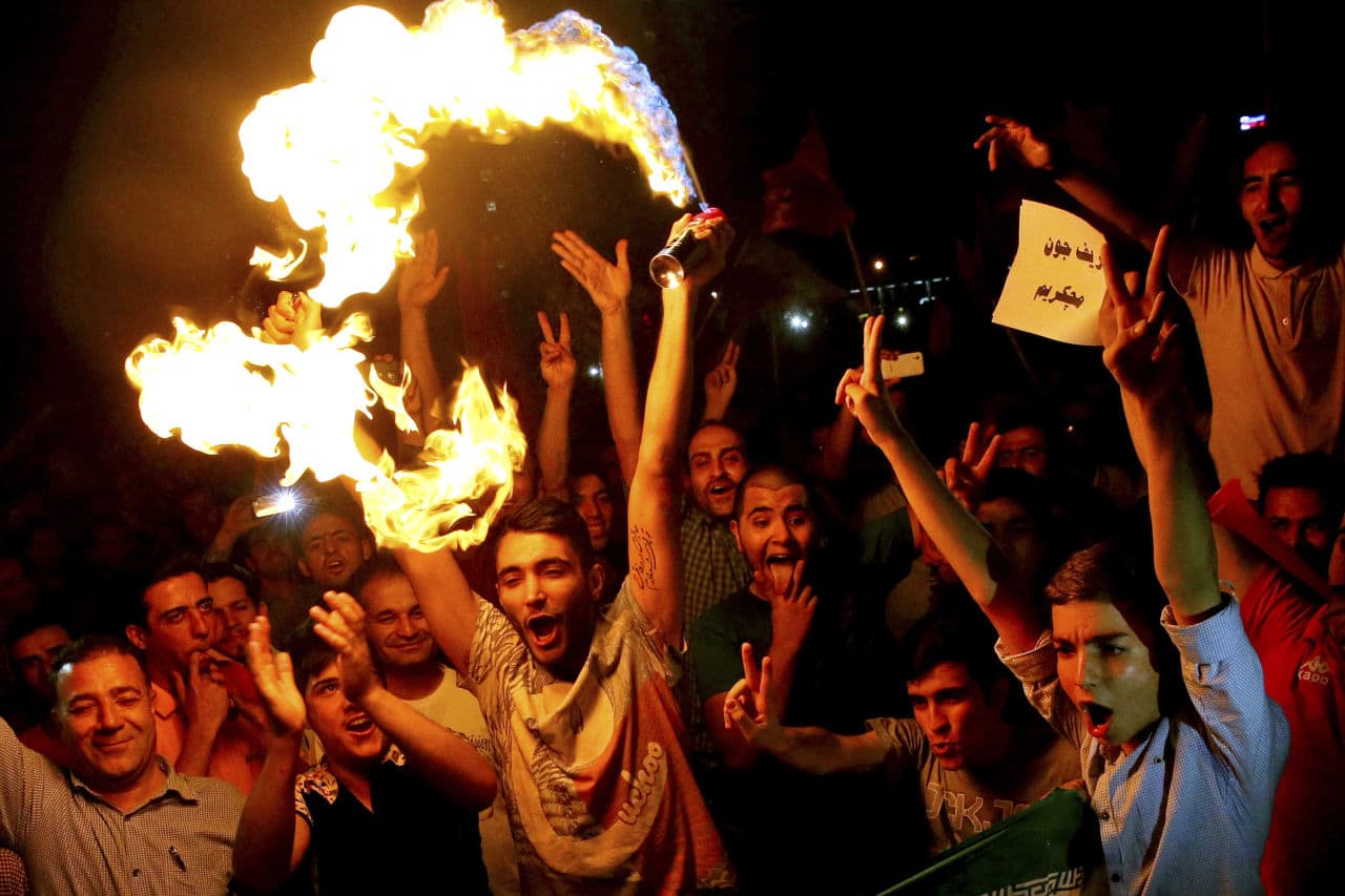 Iranians celebrate following a landmark nuclear deal in Tehran, Iran, Tuesday, July 14, 2015. (AP Photo/Ebrahim Noroozi)