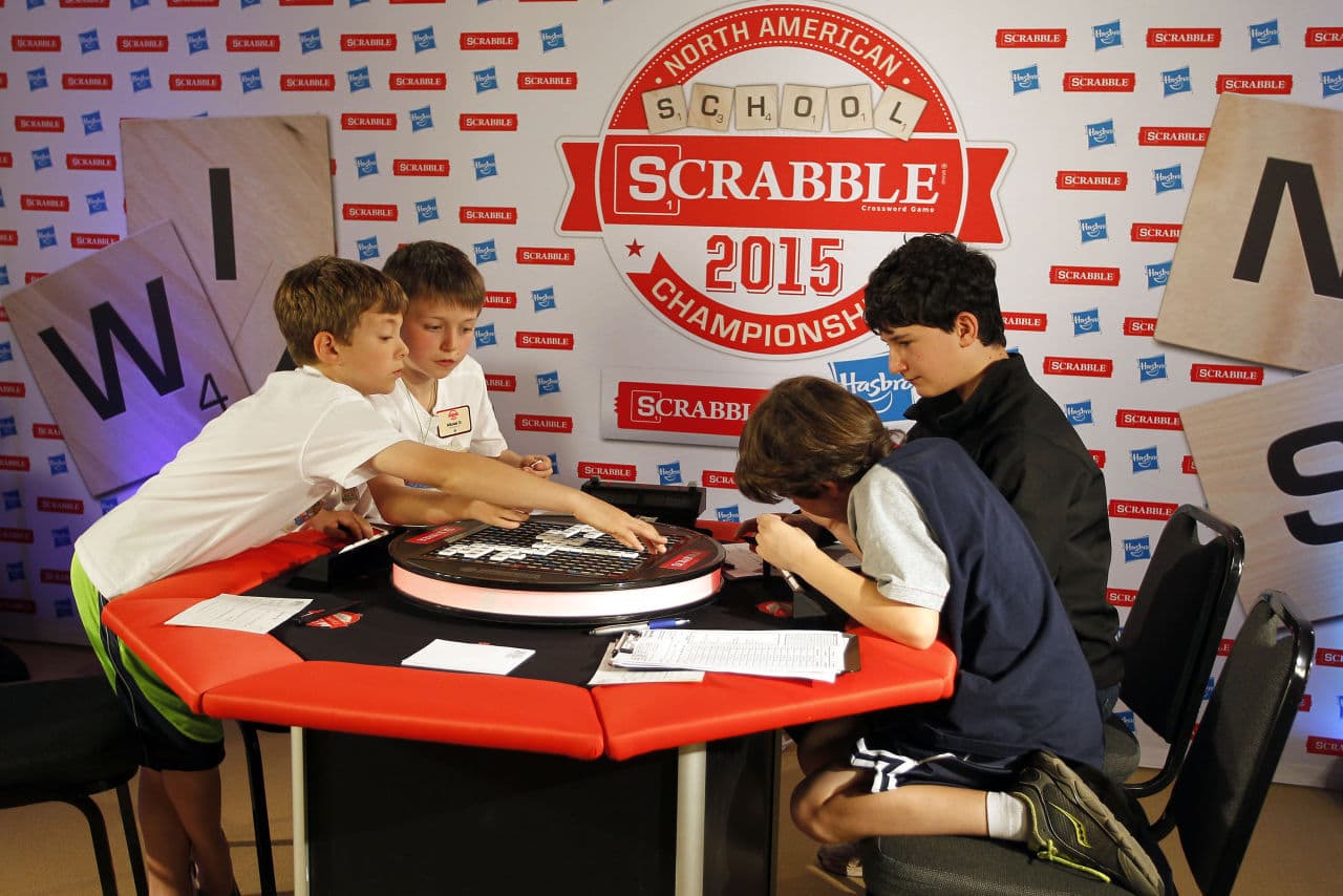 Freddy Osborne, left, and teammate Nikolai Darken, second left, both from Fairfield, Conn., play a word against teammates Yanni Raymond, right, and Knox Daniel, second right, both from Charlottesville, Va., during the first round at the 2015 North American School SCRABBLE Championship at Hasbro headquarters in Pawtucket, R.I., Saturday, May 16, 2015.  (AP)