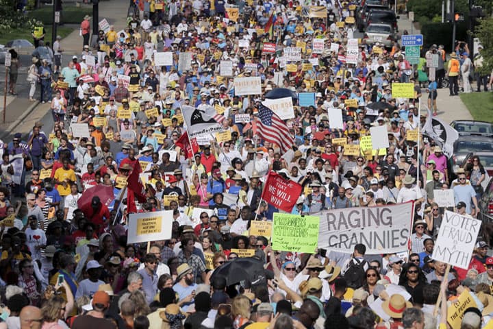 Demonstrators march through the streets of Winston-Salem, N.C., Monday, July 13, 2015 after the beginning of a federal voting rights trial challenging a 2013 state law. Election law experts say the case could determine how far Southern states can change voting rules after the nation's highest court struck down a portion of the federal Voting Rights Act just weeks before the North Carolina law was passed. (AP)